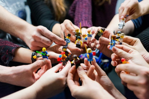 people-holding-miniature-figures.jpg people holding miniature figures